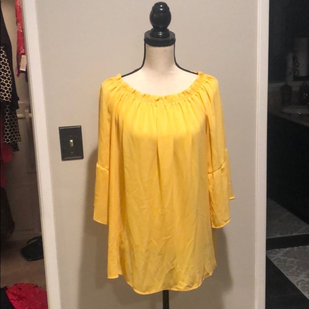 Yellow off the shoulder blouse.